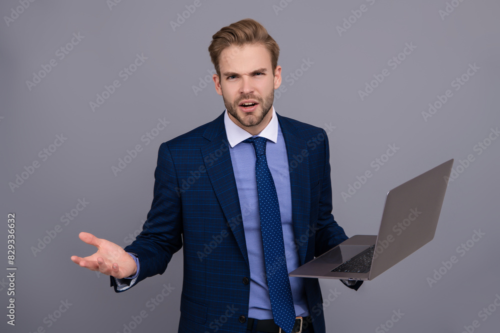 Remote online working. Business blog success. Businessman using laptop isolated on grey. Freelancer working online. Man has online blog. Businessman in suit with laptop in office. Confusing news Remote online working. Business blog success. Businessman using laptop isolated on grey. Freelancer working online. Man has online blog. Businessman in suit with laptop in office. Confusing news