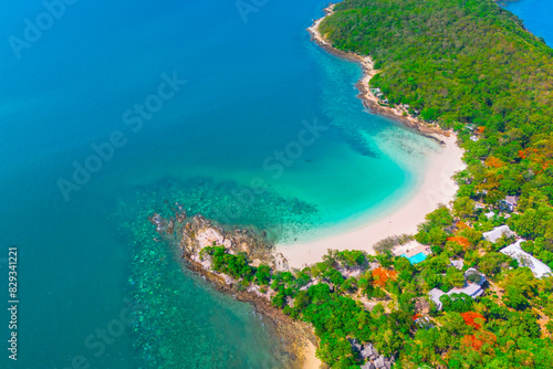 Beach with beautiful coastline. Tropical bay surrounded by coral reefs  aerial top view