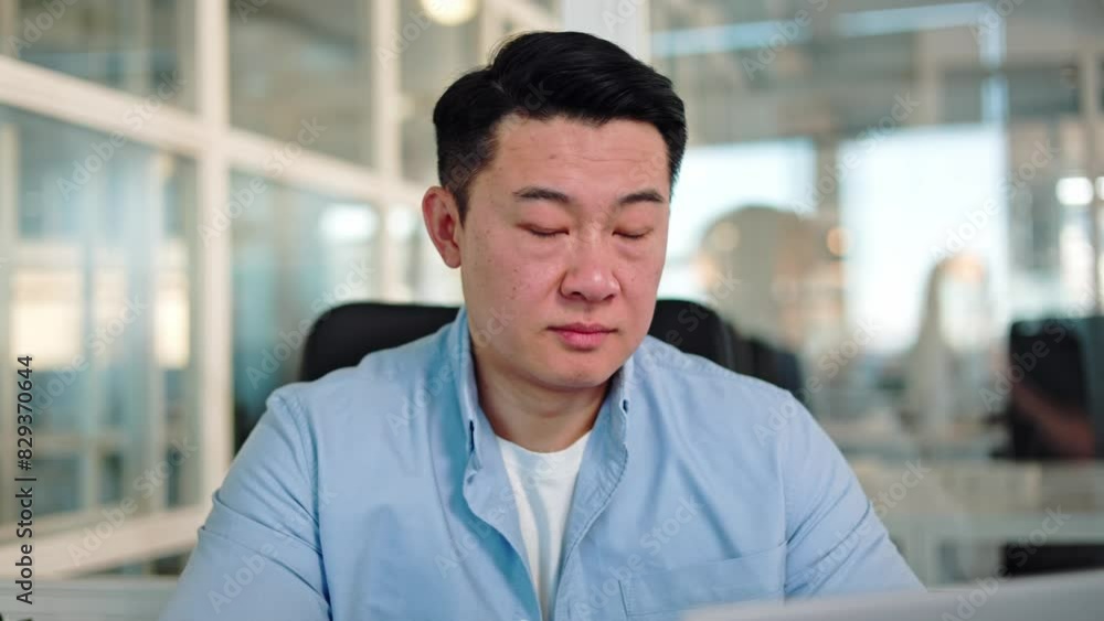 Portrait of concerned chinese person with black hair looking at screen of electronic gadget and turning head to camera. Positive administrator getting interrupted from work and smiling widely. Portrait of concerned chinese person with black hair looking at screen of electronic gadget and turning head to camera. Positive administrator getting interrupted from work and smiling widely.