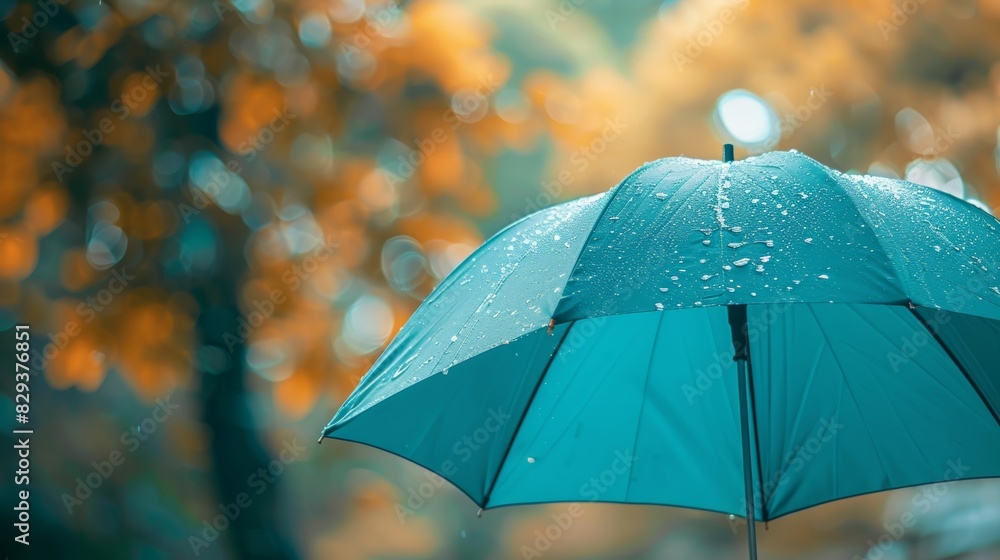Teal umbrella in focus, soft blurred background, designed with space for text, aerial shot
