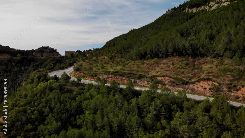 Mountain road with traffic pssing by at Montserrat mountain, Barcelona, Cataloia, Spain. High quality 4k drone view footage Mountain road with traffic pssing by at Montserrat mountain, Barcelona, Cataloia, Spain. High quality 4k drone view footage