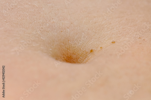 Macro photo of a woman's navel.