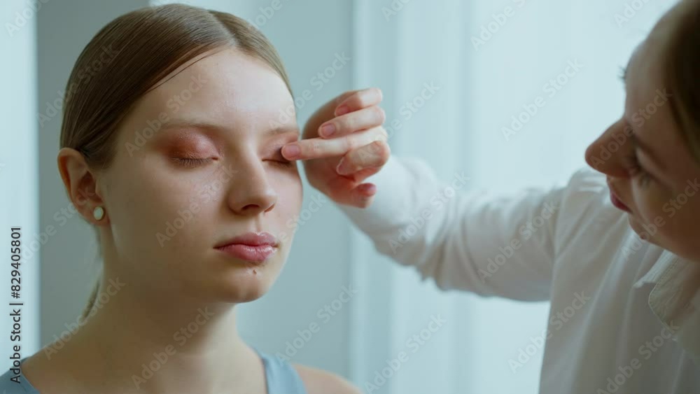 Makeup artist work in her beauty studio. Portrait of Woman applying by professional make up master. Makeup artist work in her beauty studio. Portrait of Woman applying by professional make up master.