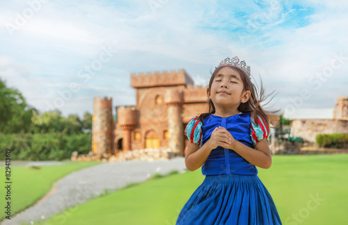dream of asian girl kid to be princesses with castle on background