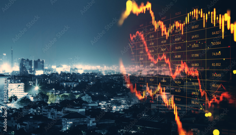 Abstract downward red forex candlestick hologram on blurry night city backdrop. Financial crisis, stock and recession concept. Double exposure.