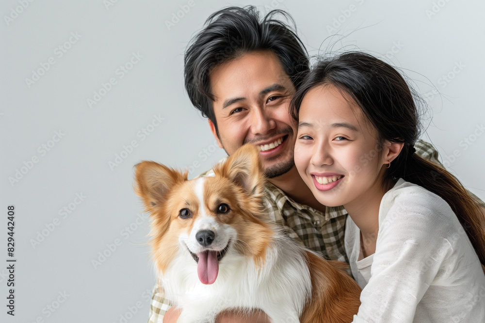 Portrait of a happy young family or Pet lovers are playing with dog and taking care each other , hug dog in owner's arms. having a dog like a kids. Portrait of a happy young family or Pet lovers are playing with dog and taking care each other , hug dog in owner's arms. having a dog like a kids.