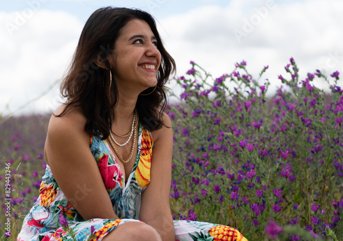 Latin woman laughing in a field of flowers