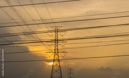 High voltage poles, wires, golden sun background © Pintira