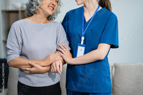 young caregiver assists her elderly woman patient at a nursing home. senior woman is assisted by a nurse at home. photo