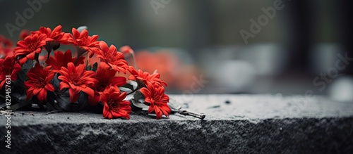Red flowers on the grave. copy space available