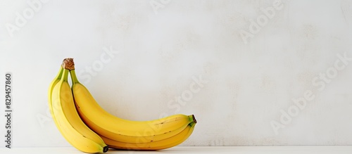 a ripe banana on a white textured background with copy space photo