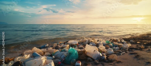 Plastic bags on the beach in the morning Garbage pollution. copy space available