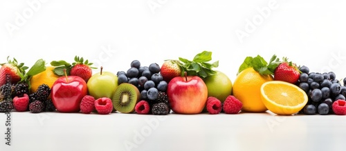 Different ripe fruits and berries lie in a solid layer on the white High quality photo. copy space available