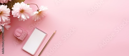 Flat lay composition with smartphone and stationery on pink background. copy space available