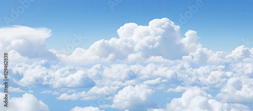 Fototapeta Naklejka Na Ścianę i Meble -  White fkuffy small clouds on the light blue sky. copy space available