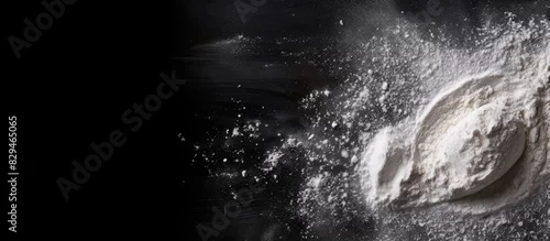 Panel kuchenny z motywem A top view of a black background with sprinkled flour creating a baking ambiance There is ample copy space in the image
