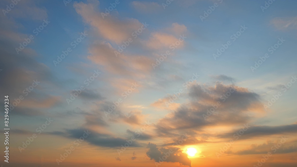 A serene sunset with the sun partially visible near the horizon, casting a warm golden glow. The sky transitions from soft blue to warm orange, with scattered clouds reflecting the sunset's colors.
A serene sunset with the sun partially visible near the horizon, casting a warm golden glow. The sky transitions from soft blue to warm orange, with scattered clouds reflecting the sunset's colors.