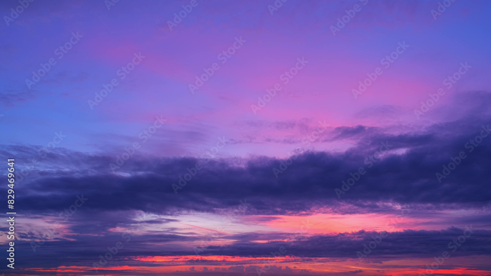 A stunning sunrise with a sky transitioning through shades of deep purples, pinks, and blues. The horizon glows with the first light of dawn, creating a serene and captivating scene. Cloud background. A stunning sunrise with a sky transitioning through shades of deep purples, pinks, and blues. The horizon glows with the first light of dawn, creating a serene and captivating scene. Cloud background.