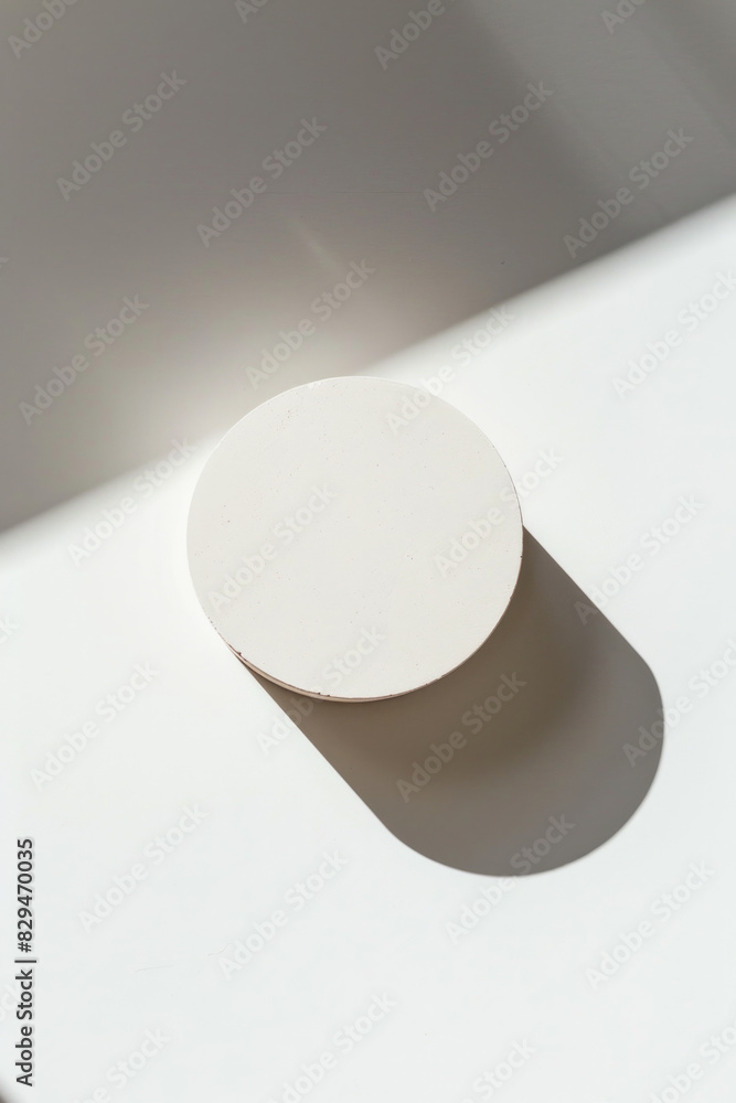 A simple, clean white background with a single, modern element like a perfectly round shadow A simple, clean white background with a single, modern element like a perfectly round shadow