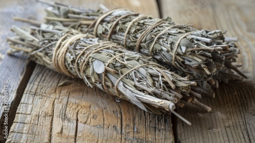 A bundle of dried sage tied with twine known for its reputation as a natural bug repellent during outdoor gatherings.