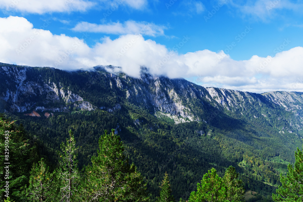 Amazing mountain views in summer. Mountain peaks in the clouds. Amazing mountain views in summer. Mountain peaks in the clouds.