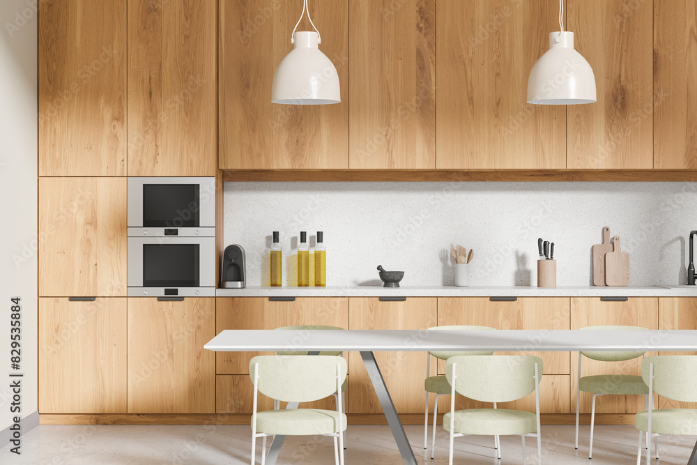 Wooden home kitchen interior with dining table and chairs, cooking cabinet Wooden home kitchen interior with dining table and chairs, cooking cabinet