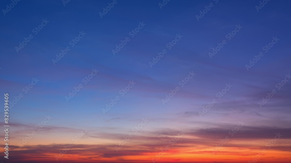 A serene sunrise with the sky transitioning from deep blue to shades of purple, pink, and orange near the horizon. Wispy clouds add texture to the sky, enhancing the tranquil ambiance.
A serene sunrise with the sky transitioning from deep blue to shades of purple, pink, and orange near the horizon. Wispy clouds add texture to the sky, enhancing the tranquil ambiance.