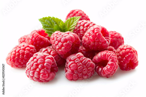 a pile of raspberries with a leaf