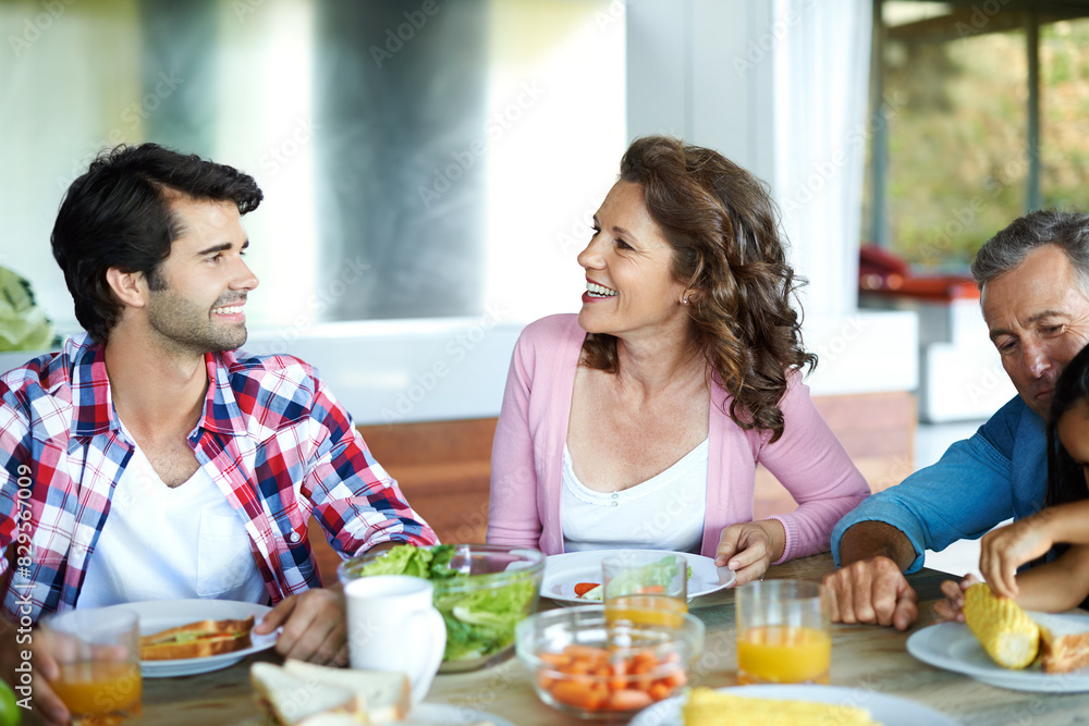 Happy, family and healthy brunch at table together for wellness, salad and juice for nutrition. Diversity, Man or woman with joy in home or happiness for diet with fresh vegetables, eating with smile Happy, family and healthy brunch at table together for wellness, salad and juice for nutrition. Diversity, Man or woman with joy in home or happiness for diet with fresh vegetables, eating with smile
