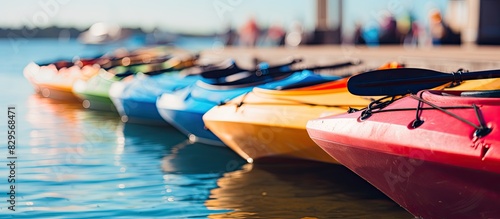 Fototapeta Naklejka Na Ścianę i Meble -  Colorful ocean kayaks lined up on the dock with abstract background Great copy space image