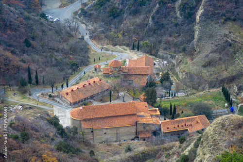 Top view of monastery complex. Road to church, Buildings with tiled roofs. Shio-mgvime monastery. photo