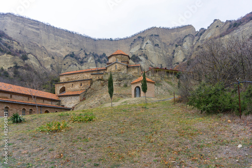 Church and buildings with of the monastery complex. A rock with cells is visible. Shio-mgvime monastery. photo