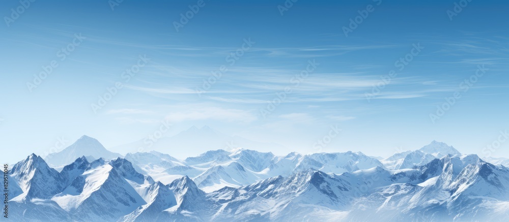 Snow covered mountains set against a clear blue sky with copy space image available