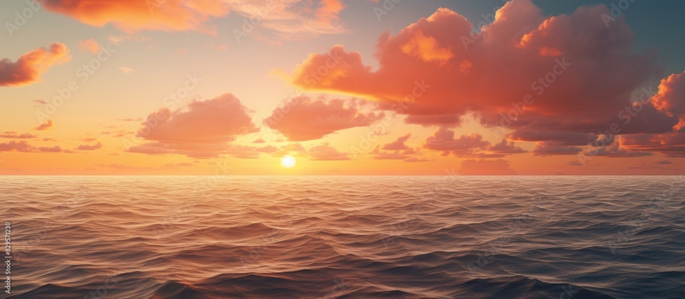 Fototapeta premium Orange clouds at sunset over the ocean creating a picturesque scene with a copy space image