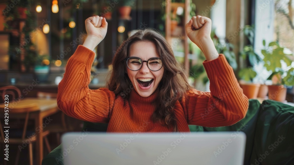 Excited woman celebrating online success at work or school. Laptop ...