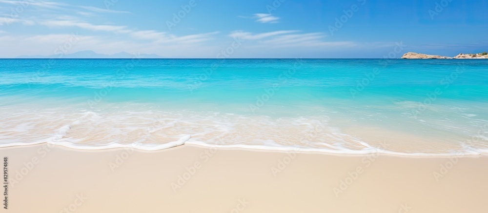 Sea with golden sand beach and clear blue waters ideal for vacation concept with copy space image