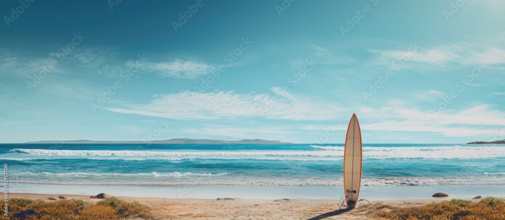 Surfer standing with a surfboard on the seashore with a beautiful background for your copy space image Surfer standing with a surfboard on the seashore with a beautiful background for your copy space image