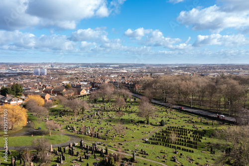 Aerial photo overlooking a grave yard cemetery in the autumn time  taken in the village of Beeston in Leeds West Yorkshire UK showing the large grave stone and trees