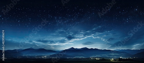 A serene summer night with a dark blue sky filled with twinkling stars light white clouds moving swiftly creating a peaceful atmosphere. Copy space image. Place for adding text and design photo