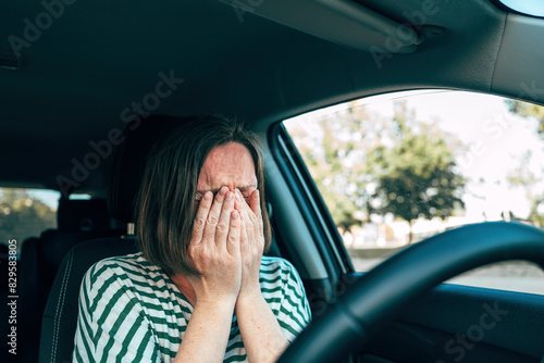 Sad disappointed female driver crying in car
