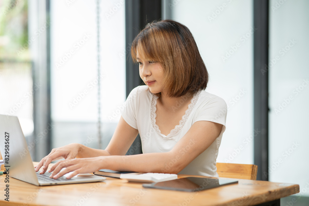 Asian businesswoman working on documents at office Asian businesswoman working on documents at office