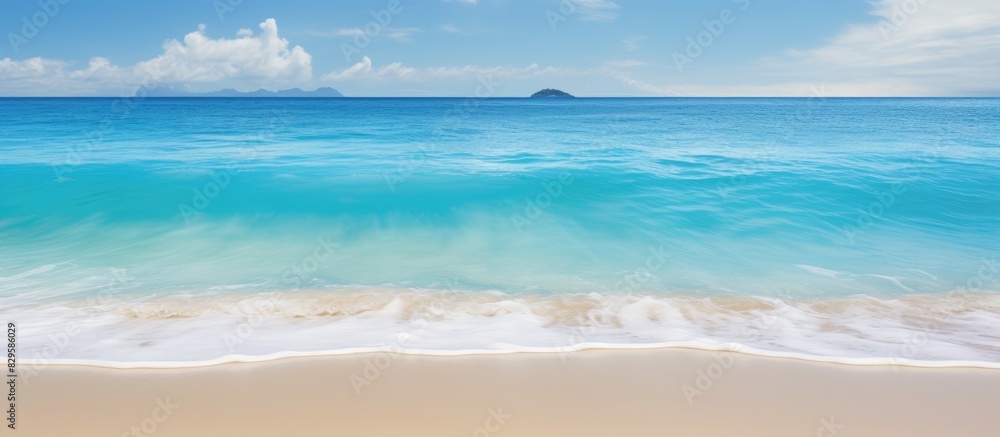 Obraz premium Caribbean sea lapping against sandy shores creating a serene tropical scene with pristine beaches and crystal clear waters in the background of a copy space image
