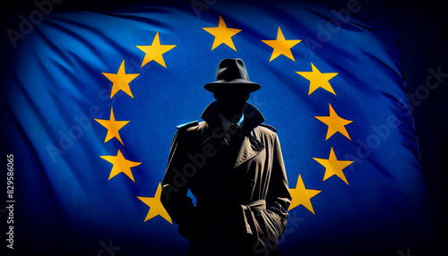 Silhouette of a spy in a trench coat and hat in front of the European Union flag. Concept of espionage, intelligence, and geopolitical intrigue in the EU. 