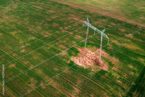 Transmission tower with four electric wires from drone point of view, aerial view