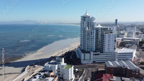 Beachfront holiday apartment buildings and False Bay coast in Strand Western Cape camera moving passed apartment buidlings photo