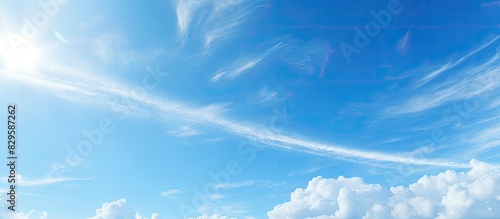 Nature background with clear blue sky and a plane s condensation trail against it providing copy space image