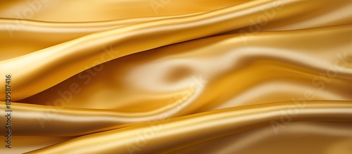 Gold luxury satin fabric texture for background. Copy space image. Place for adding text and design © Ilgun
