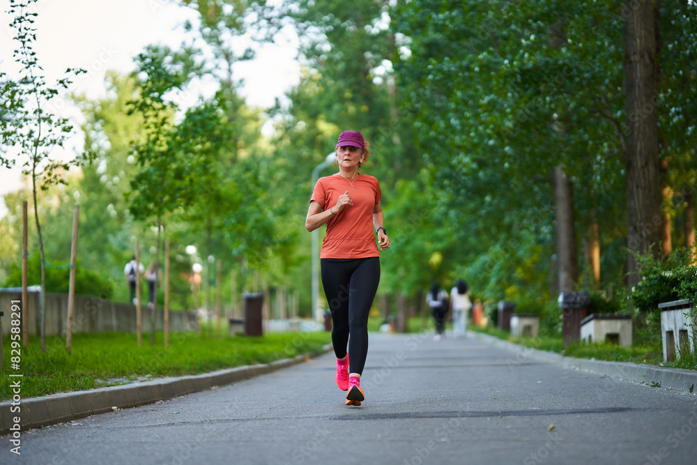 Athletic mature woman running in the park Athletic mature woman running in the park
