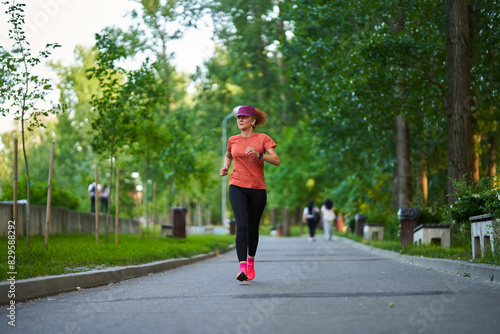 Athletic mature woman running in the park