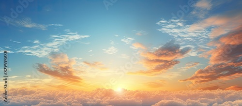 An incredible summer sunset view with a beautiful yellow and orange sky above a sun drenched blue sky with clouds providing ample copy space image photo